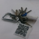QR Code Keychain. Photo has been altered to protect the phone number encoded on the fob.