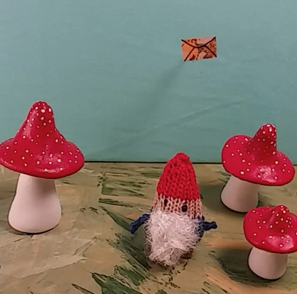 a hand made scene of a gnome and mushrooms